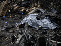 The body of a person killed by a Russian missile strike lies on the street in central Kyiv, Ukraine, on December 20, 2024. (