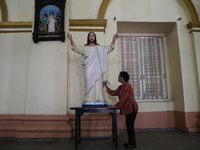 A woman cleans a statue of Jesus Christ inside a church in Kolkata, India, on December 20, 2024, ahead of Christmas celebrations. (