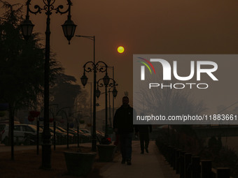 The sun sets on a cold winter evening in Srinagar, Jammu and Kashmir, on December 20, 2024. Kashmir remains in the grip of a cold wave, with...