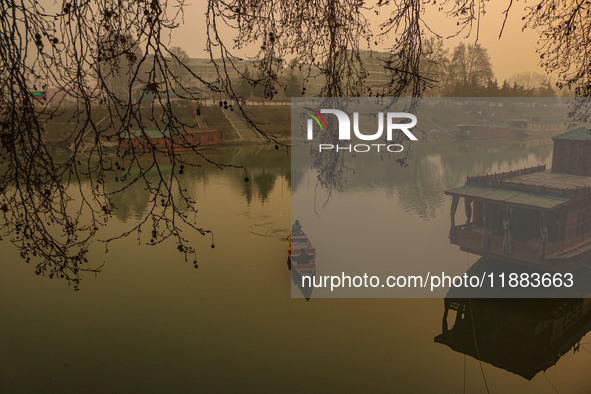 A man rows a boat on the waters of the Jhelum River in Srinagar, Jammu and Kashmir, on December 20, 2024. Kashmir remains in the grip of a c...