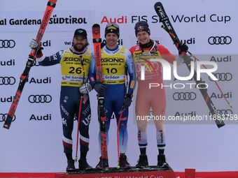 (From left to right) Jared Goldberg of Team United States in second place, Mattia Casse of Team Italy in first place, and Marco Odermatt of...