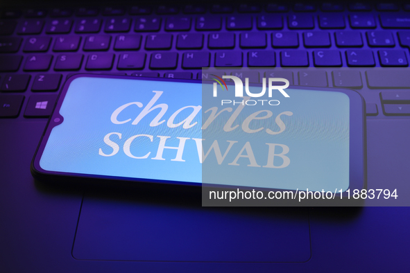 The Charles Schwab Corporation logo appears on a smartphone screen in this illustration photo in Reno, United States, on December 20, 2024. 