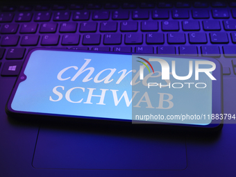 The Charles Schwab Corporation logo appears on a smartphone screen in this illustration photo in Reno, United States, on December 20, 2024....