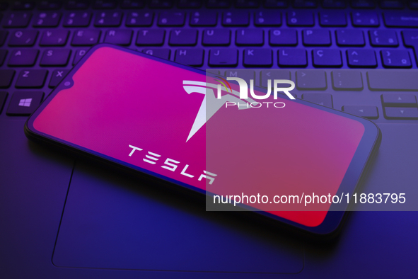 The Tesla, Inc. logo appears on a smartphone screen in this illustration photo in Reno, United States, on December 20, 2024. 