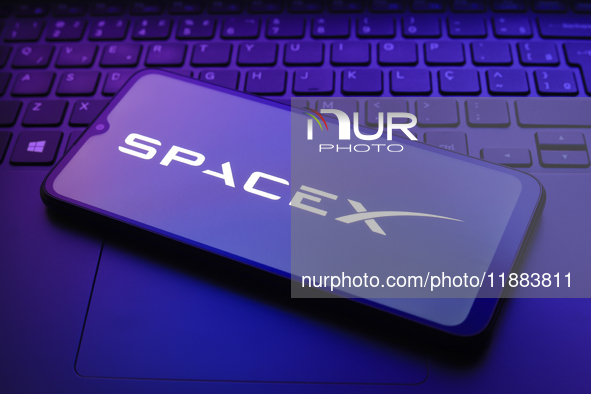 The Space Exploration Technologies Corp. (SpaceX) logo appears on a smartphone screen in this illustration photo in Reno, United States, on...