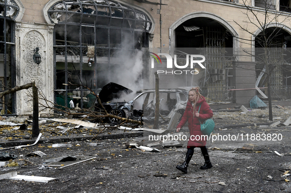 A woman walks along a street in the Holosiivskyi district covered with rubble after a Russian missile attack in Kyiv, Ukraine, on December 2...