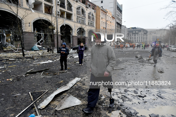 A man with a prosthetic leg walks along a street in the Holosiivskyi district covered with debris after a Russian missile attack in Kyiv, Uk...