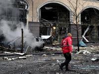 A Ukrainian Red Cross Society worker walks along a street in the Holosiivskyi district covered with rubble after a Russian missile attack in...