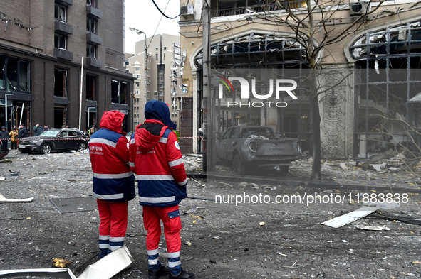 Medics stand outside a building in the Holosiivskyi district damaged by a Russian missile attack in Kyiv, Ukraine, on December 20, 2024. On...