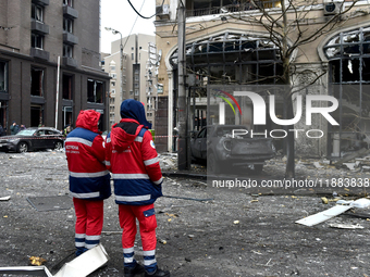 Medics stand outside a building in the Holosiivskyi district damaged by a Russian missile attack in Kyiv, Ukraine, on December 20, 2024. On...