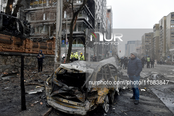 In Kyiv, Ukraine, on December 20, 2024, a man stands by a calcinated car in the Holosiivskyi district after a Russian missile attack. On Fri...