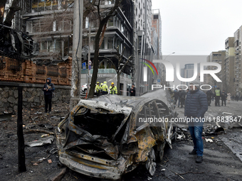 In Kyiv, Ukraine, on December 20, 2024, a man stands by a calcinated car in the Holosiivskyi district after a Russian missile attack. On Fri...