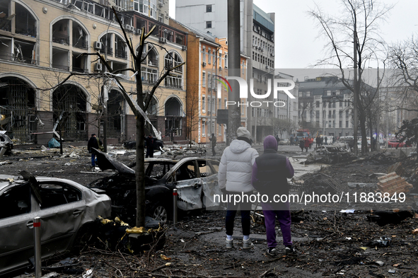 People look at damage caused by a Russian missile attack in the Holosiivskyi district, Kyiv, capital of Ukraine, on December 20, 2024. On Fr...