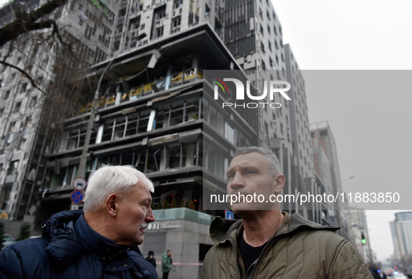 In Kyiv, Ukraine, on December 20, 2024, Kyiv city head Vitali Klitschko (R) looks at buildings in the Holosiivskyi district damaged by a Rus...