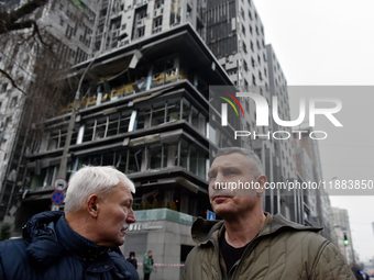 In Kyiv, Ukraine, on December 20, 2024, Kyiv city head Vitali Klitschko (R) looks at buildings in the Holosiivskyi district damaged by a Rus...