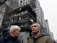 In Kyiv, Ukraine, on December 20, 2024, Kyiv city head Vitali Klitschko (R) looks at buildings in the Holosiivskyi district damaged by a Rus...