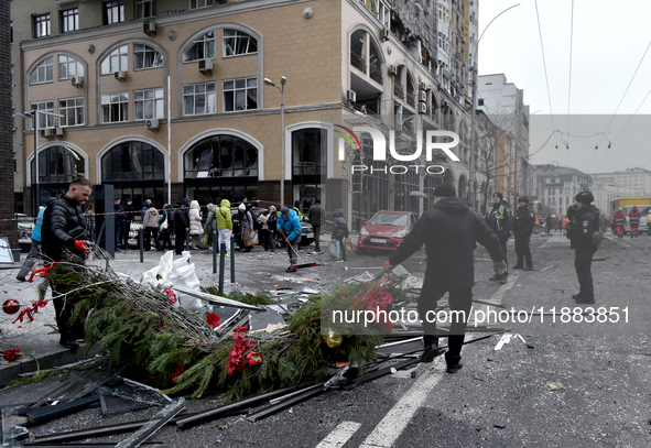 In Kyiv, Ukraine, on December 20, 2024, men remove Christmas decorations from the street in the Holosiivskyi district affected by a Russian...