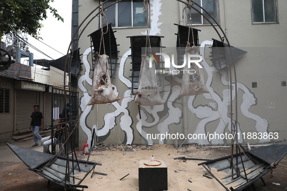 A man walks past an art installation inside an alley during an open-air art festival, The Behala Art Fest, in Kolkata, India, on December 20...