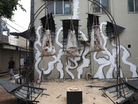 A man walks past an art installation inside an alley during an open-air art festival, The Behala Art Fest, in Kolkata, India, on December 20...