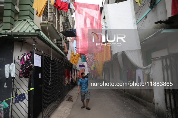 A man walks under an art installation inside an alley during an open-air art festival, The Behala Art Fest, in Kolkata, India, on December 2...