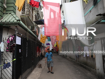 A man walks under an art installation inside an alley during an open-air art festival, The Behala Art Fest, in Kolkata, India, on December 2...