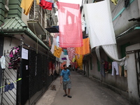 A man walks under an art installation inside an alley during an open-air art festival, The Behala Art Fest, in Kolkata, India, on December 2...