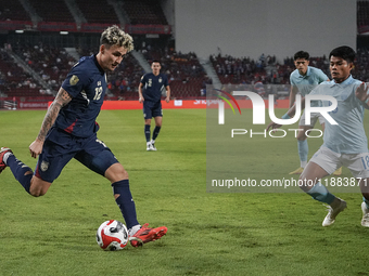 Nicholas Mickelson of Thailand plays against Seut Baraing of Cambodia during the Mitsubishi Electric Cup 2004 Group A match between Thailand...