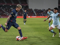 Nicholas Mickelson of Thailand plays against Seut Baraing of Cambodia during the Mitsubishi Electric Cup 2004 Group A match between Thailand...