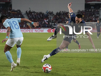 Seut Baraing of Cambodia competes against James Beresford of Thailand during the Mitsubishi Electric Cup 2004 Group A match between Thailand...