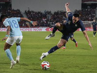 Seut Baraing of Cambodia competes against James Beresford of Thailand during the Mitsubishi Electric Cup 2004 Group A match between Thailand...