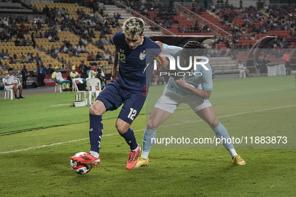 Nicholas Mickelson of Thailand plays against Nick Taylor of Cambodia during the Mitsubishi Electric Cup 2004 Group A match between Thailand...