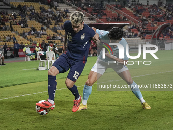 Nicholas Mickelson of Thailand plays against Nick Taylor of Cambodia during the Mitsubishi Electric Cup 2004 Group A match between Thailand...