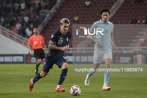 Nicholas Mickelson of Thailand competes against Takaki Ose of Cambodia during the Mitsubishi Electric Cup 2004 Group A match between Thailan...