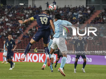 William Weidersjo of Thailand competes against Soeuy Visal of Cambodia during the Mitsubishi Electric Cup 2004 Group A match between Thailan...