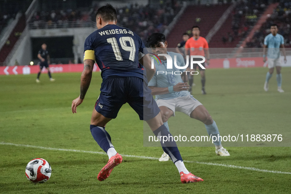 William Weidersjo of Thailand competes against Seut Baraing of Cambodia during the Mitsubishi Electric Cup 2004 Group A match between Thaila...