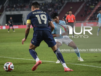 William Weidersjo of Thailand competes against Seut Baraing of Cambodia during the Mitsubishi Electric Cup 2004 Group A match between Thaila...