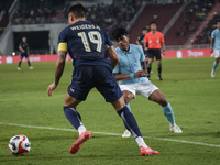 William Weidersjo of Thailand competes against Seut Baraing of Cambodia during the Mitsubishi Electric Cup 2004 Group A match between Thaila...