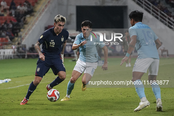 Nicholas Mickelson of Thailand plays against Nick Taylor of Cambodia during the Mitsubishi Electric Cup 2004 Group A match between Thailand...