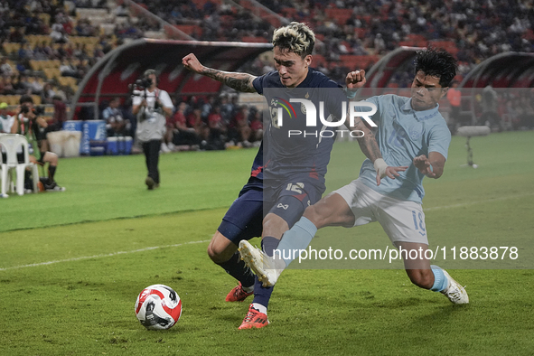 Nicholas Mickelson of Thailand plays against Seut Baraing of Cambodia during the Mitsubishi Electric Cup 2004 Group A match between Thailand...