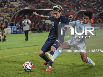 Nicholas Mickelson of Thailand plays against Seut Baraing of Cambodia during the Mitsubishi Electric Cup 2004 Group A match between Thailand...