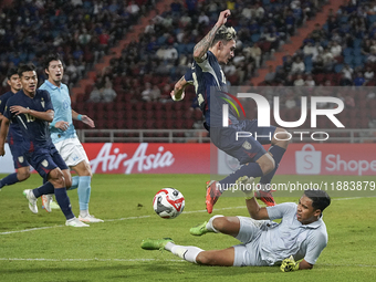 Nicholas Mickelson of Thailand competes against Reth Ly Heng of Cambodia during the Mitsubishi Electric Cup 2004 Group A match between Thail...