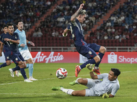 Nicholas Mickelson of Thailand competes against Reth Ly Heng of Cambodia during the Mitsubishi Electric Cup 2004 Group A match between Thail...