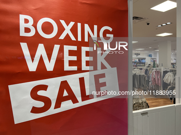 A sign for a Boxing Day sale is in the window of a store at a shopping mall in Toronto, Ontario, Canada, on December 19, 2024. 