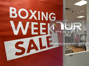 A sign for a Boxing Day sale is in the window of a store at a shopping mall in Toronto, Ontario, Canada, on December 19, 2024. (