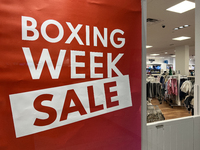 A sign for a Boxing Day sale is in the window of a store at a shopping mall in Toronto, Ontario, Canada, on December 19, 2024. (