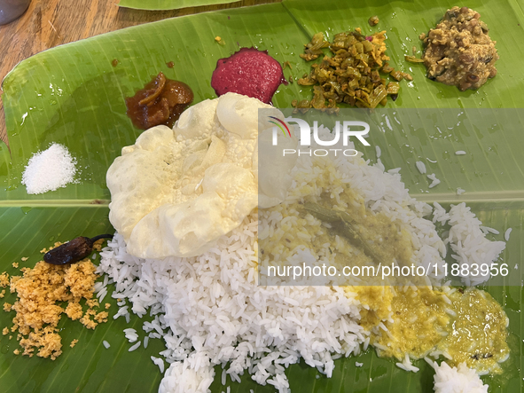 A traditional sadya meal is served on a banana leaf in Thiruvananthapuram, Kerala, India, on April 2, 2024. Sadya is a meal of Kerala origin...