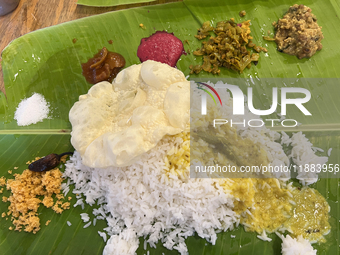 A traditional sadya meal is served on a banana leaf in Thiruvananthapuram, Kerala, India, on April 2, 2024. Sadya is a meal of Kerala origin...