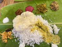 A traditional sadya meal is served on a banana leaf in Thiruvananthapuram, Kerala, India, on April 2, 2024. Sadya is a meal of Kerala origin...