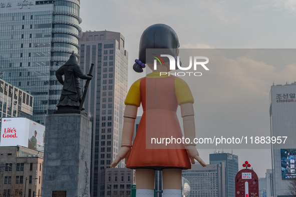 Behind Young-hee, a robotic doll from Netflix's ''Squid Game,'' stands at Gwanghwamun Square in Seoul, South Korea, on December 20, 2024. ''...