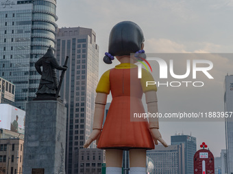 Behind Young-hee, a robotic doll from Netflix's ''Squid Game,'' stands at Gwanghwamun Square in Seoul, South Korea, on December 20, 2024. ''...